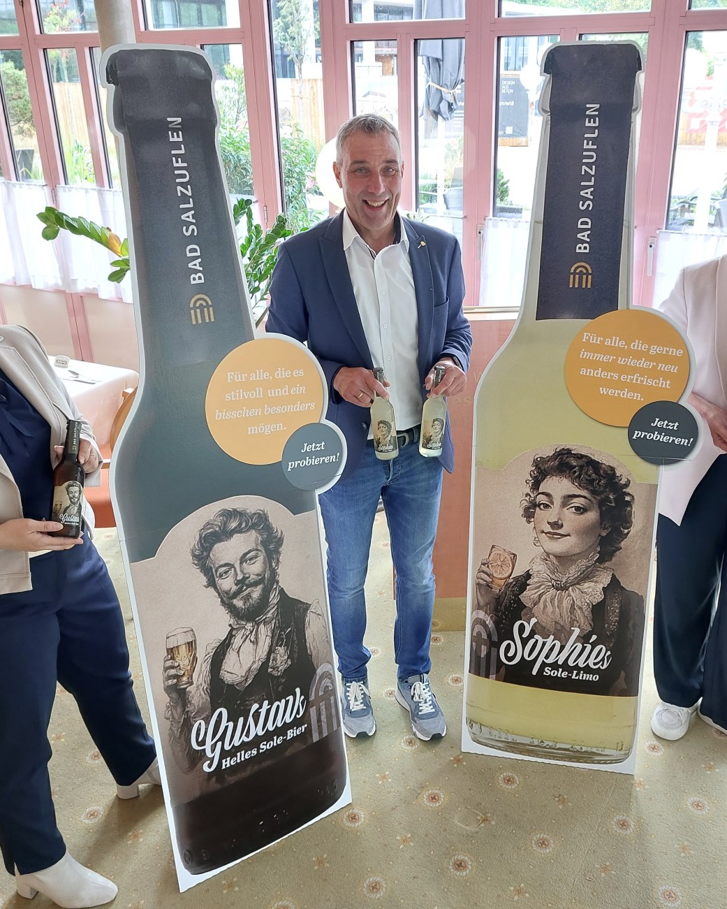Natursolehaltige Durstlöscher für die Kurstadt: Bad Salzuflens Bürgermeister Dirk Tolkemitt (Mitte), Kurparkhotel-Inhaberin Swetlana Lenger (links) und Myriam Heidemann (rechts, Fachdienstleiterin Kulturelle Bildung, Event und Stadtmarketing)
freuen sich, die neuen Getränkesorten „Gustavs Helles Sole-Bier“ und „Sophies Sole-Limo“ am 23. Juli auf
dem Roten Platz vor dem Kurgastzentrum offiziell vorzustellen., © Stadt Bad Salzuflen Natursolehaltige Durstlöscher für die Kurstadt: Bad Salzuflens Bürgermeister Dirk Tolkemitt (Mitte), Kurparkhotel-Inhaberin Swetlana Lenger (links) und Myriam Heidemann (rechts, Fachdienstleiterin Kulturelle Bildung, Event und Stadtmarketing)
freuen sich, die neuen Getränkesorten „Gustavs Helles Sole-Bier“ und „Sophies Sole-Limo“ am 23. Juli auf
dem Roten Platz vor dem Kurgastzentrum offiziell vorzustellen., © Stadt Bad Salzuflen